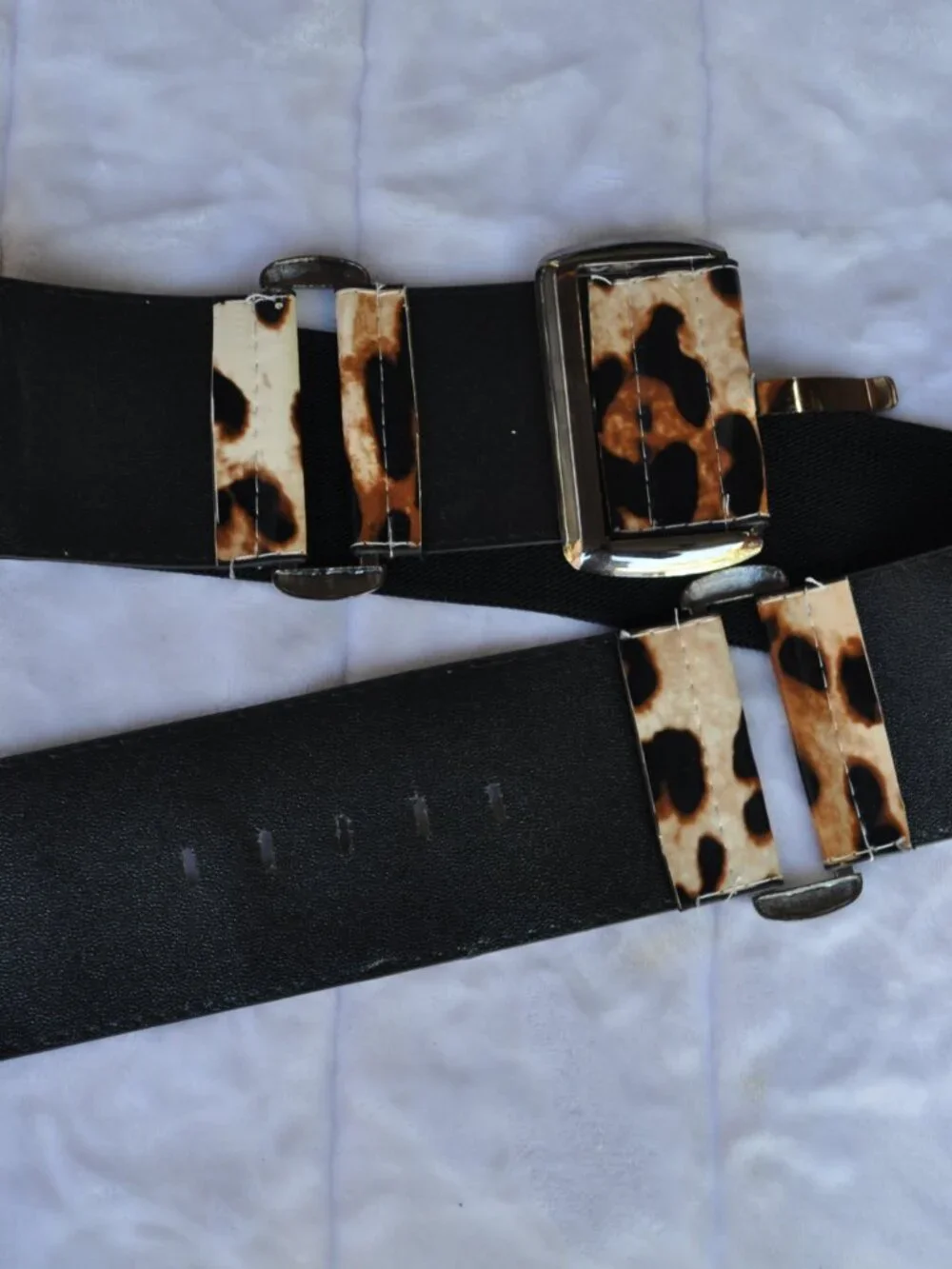 Women's wide belt features a striking leopard print pattern